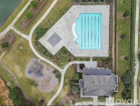 An aerial view of a building with a pool and a playground.