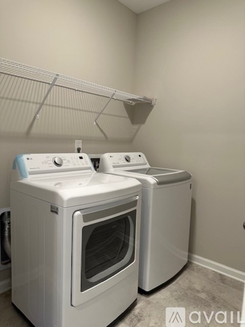 Two front loading washing machines in a laundry room.