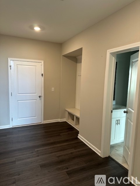 A room with a white door and a window.