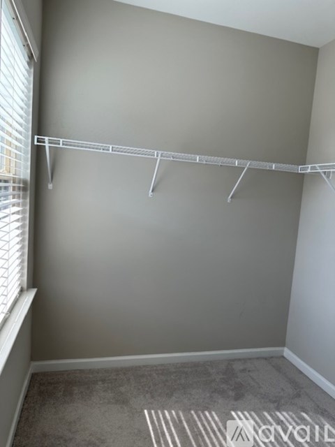A white metal rack is mounted on a wall.