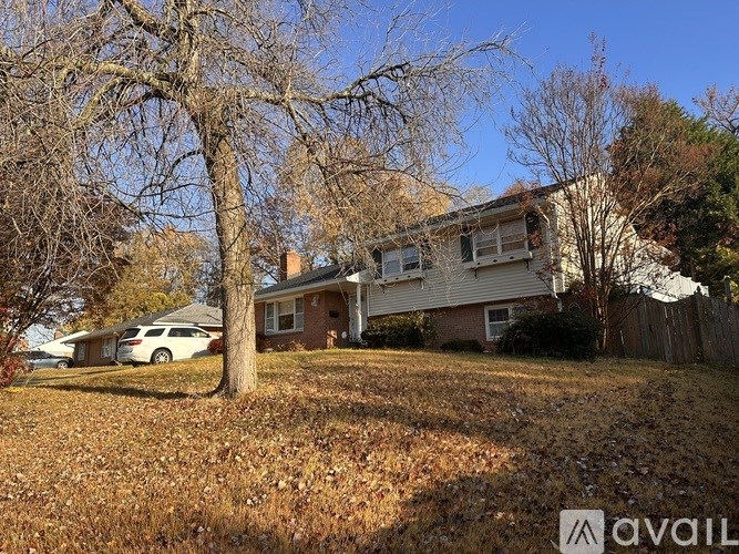 A house with a car parked in front of it.