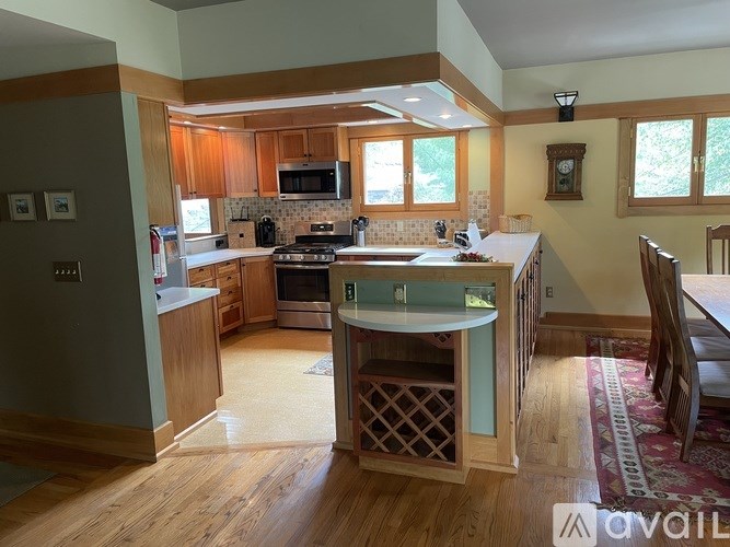 A kitchen with wooden cabinets and a white island.
