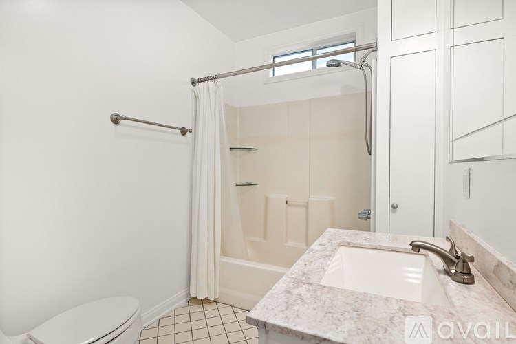 A bathroom with a marble sink and a toilet.