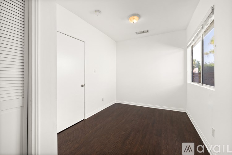 A room with a wooden floor and white walls.