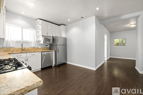 A kitchen with a granite countertop and stove top.
