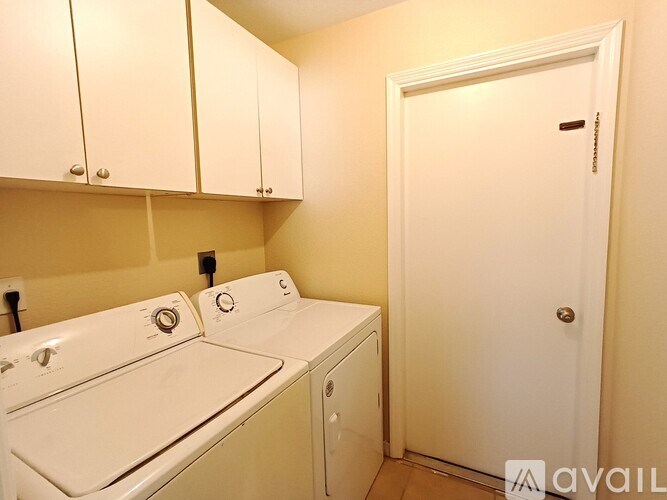 A small laundry room with a washer and dryer.