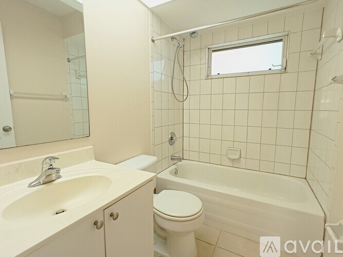 A bathroom with a sink, toilet, and bathtub.