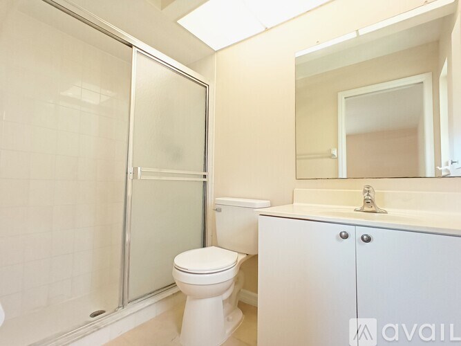A white toilet sits next to a sink in a bathroom.