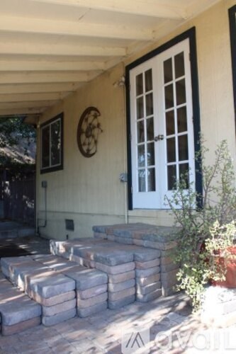 A white door with a black frame is on a tan wall.