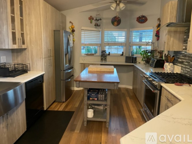 A kitchen with wooden floors and a central island.