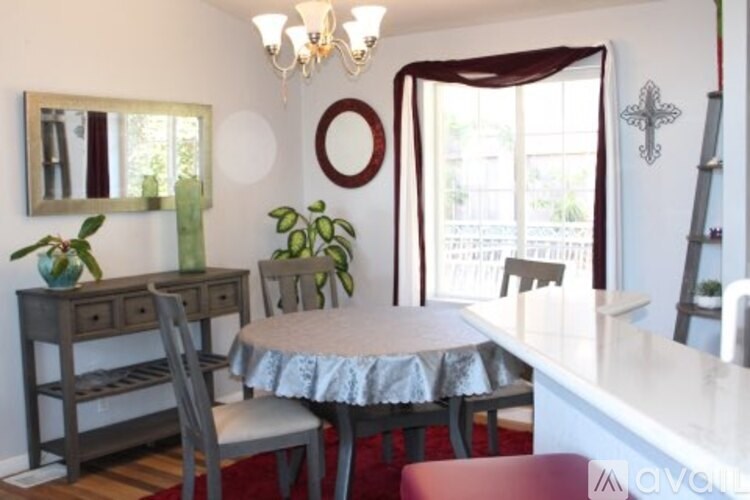 A dining room with a table and chairs.