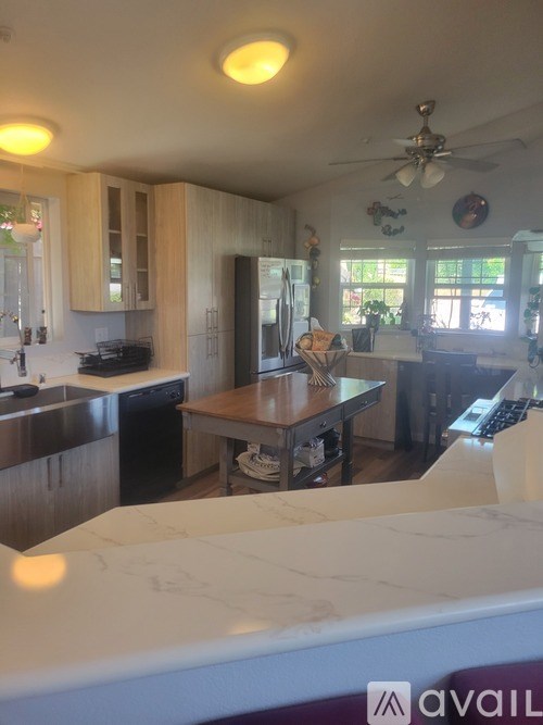 A kitchen with a table and chairs in the middle of the room.