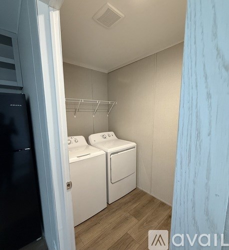 A small laundry room with a washer and dryer.