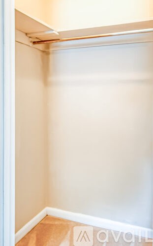 A white door is open to a room with white walls.