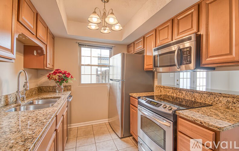 A kitchen with granite countertops and stainless steel appliances.