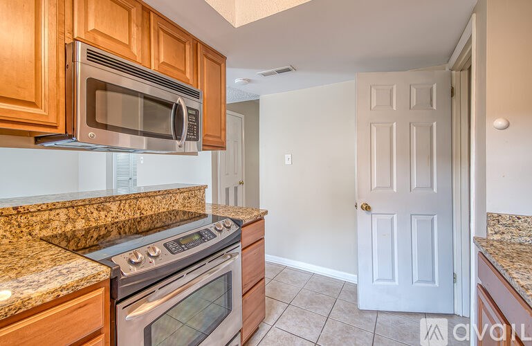 A kitchen with a stove top oven and microwave above it.