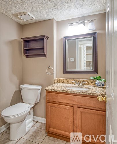 A white toilet sits next to a sink in a bathroom.
