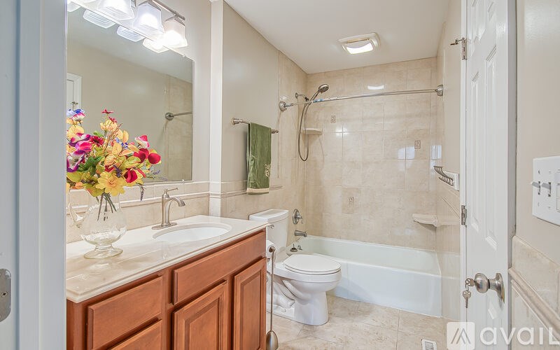 A bathroom with a sink, toilet, and bathtub.
