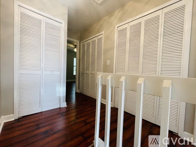 Closed white shutters on a wall.