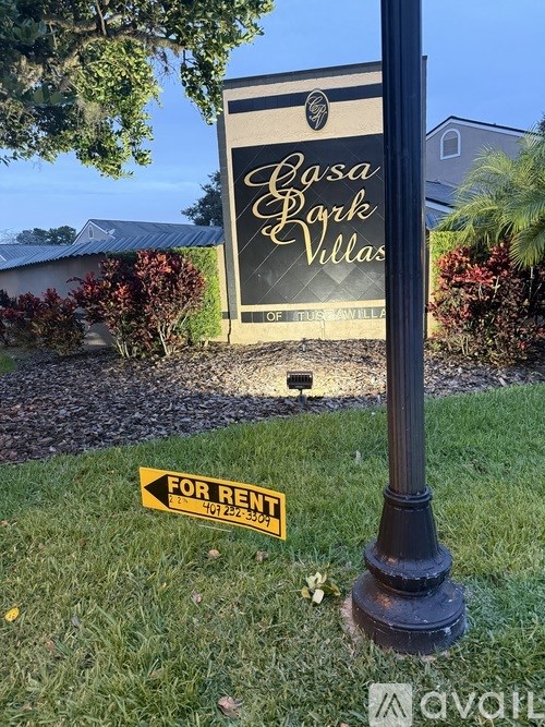 A sign for Casa Park Villas is displayed in front of a building.