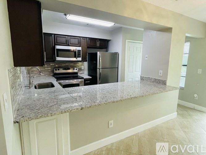A kitchen with granite countertops and stainless steel appliances.