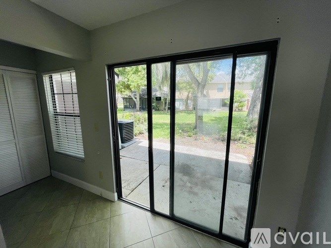 A room with a sliding glass door leading to a patio.