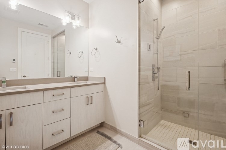 A bathroom with a walk-in shower and a sink.