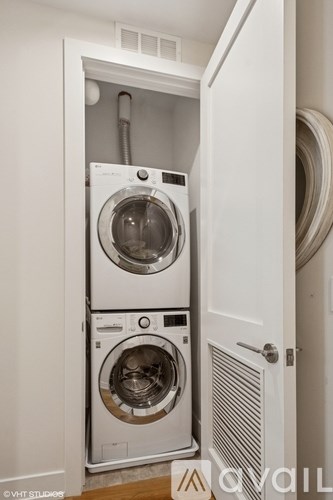 A white washing machine and dryer in a small laundry room.