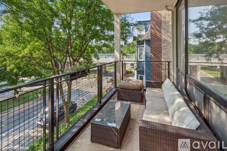 A balcony with a table and chairs overlooking a street.