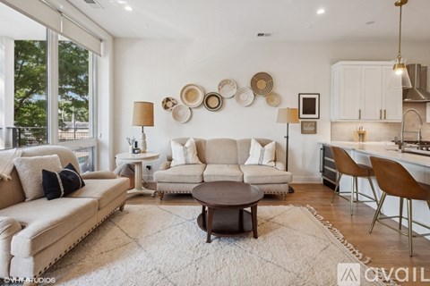 A living room with a white sofa set and a coffee table.