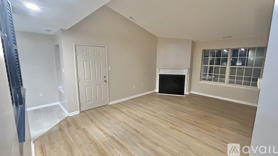 A room with a fireplace and a door is available for rent.
