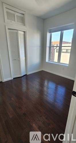 A room with wooden floors and a window.