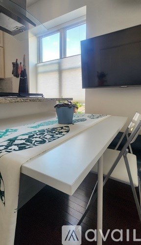 A white table with a black and white patterned tablecloth on it.