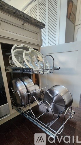 A kitchen with a rack of pots and pans.