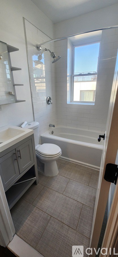 A bathroom with a toilet, sink, and bathtub.