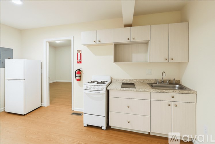 A kitchen with white appliances and cabinets.