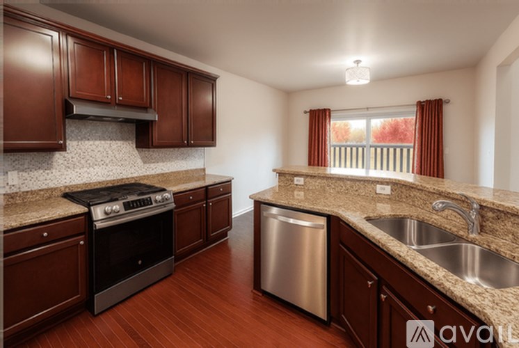A kitchen with brown cabinets and a stainless steel dishwasher.