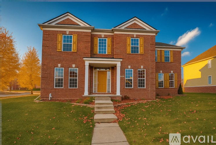 A red brick house with a yellow door and windows.