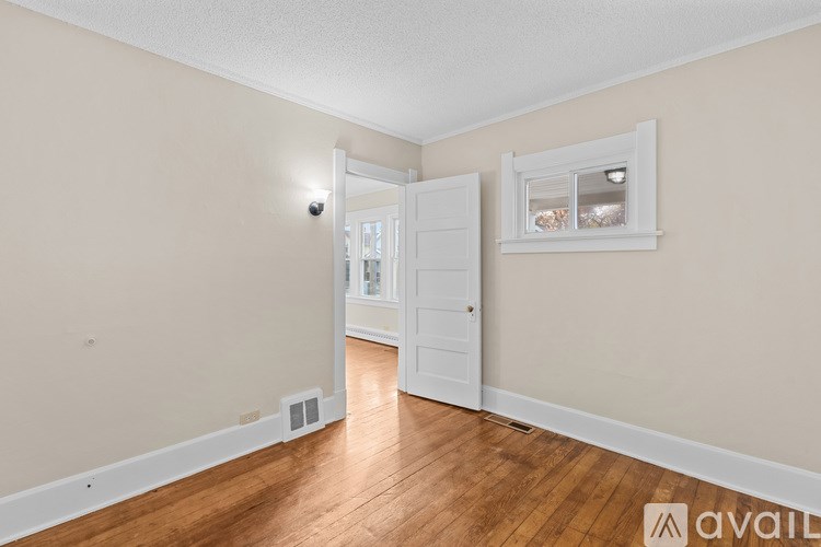 A room with a white door and a window with a white frame.