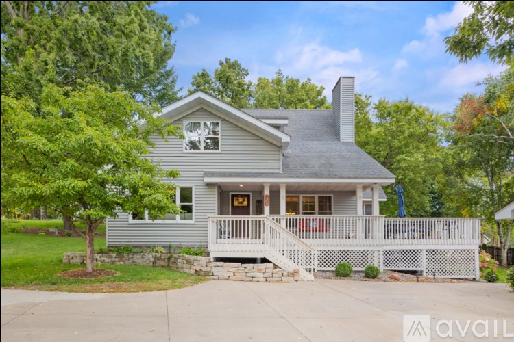 A house with a grey roof and a white porch.