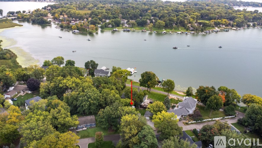 A bird's eye view of a residential area with a lake and boats.