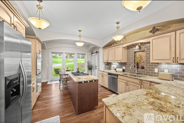 A kitchen with granite countertops and a center island.