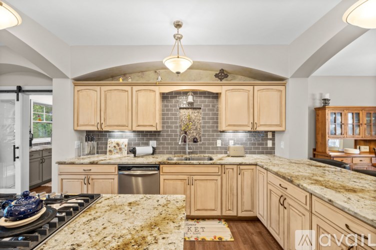 A kitchen with wooden cabinets and a granite countertop.