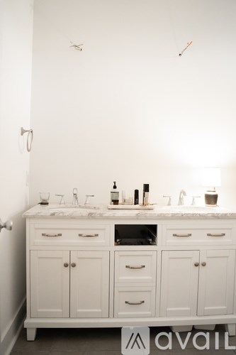 A bathroom with a white cabinet and sink.