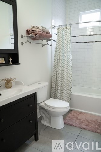 A white toilet sits next to a sink in a bathroom.