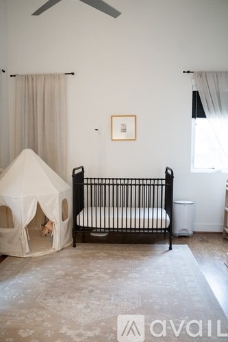 A baby room with a crib and a play tent.