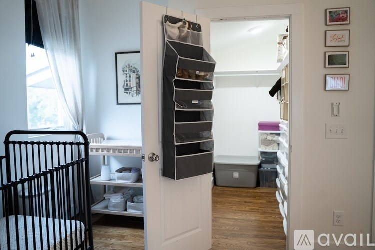 A black chair is in front of a white door.