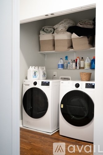 Two front loading washing machines in a laundry room.