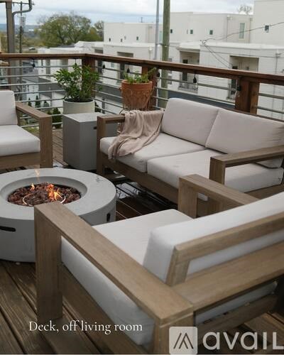 A deck off living room with a fire pit and seating area.