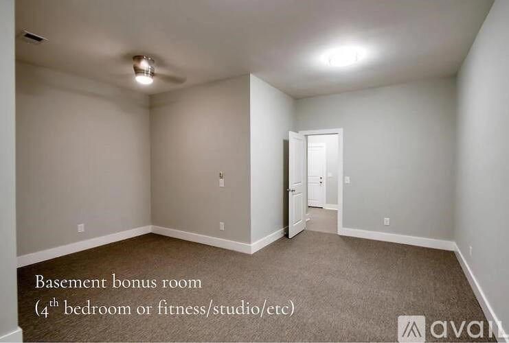 A basement bonus room with a doorway leading to another room.